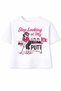 White t-shirt with a graphic of a woman playing golf and text 'Stop Looking at My Putt' on a white background.