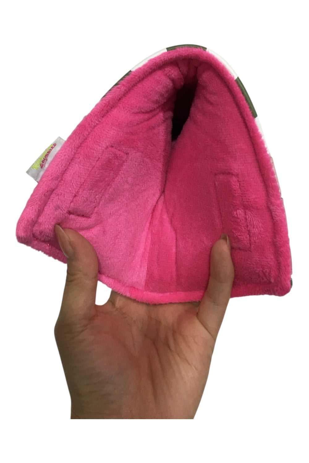 Pink pet bed held by a hand on a white background