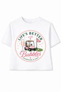 White t-shirt with a graphic design featuring a golf cart, champagne glass, and text on a white background.