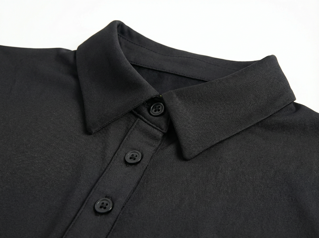 Close-up of a black polo shirt collar with buttons on a white background