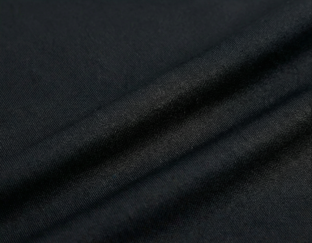 Close-up of dark black fabric with folds