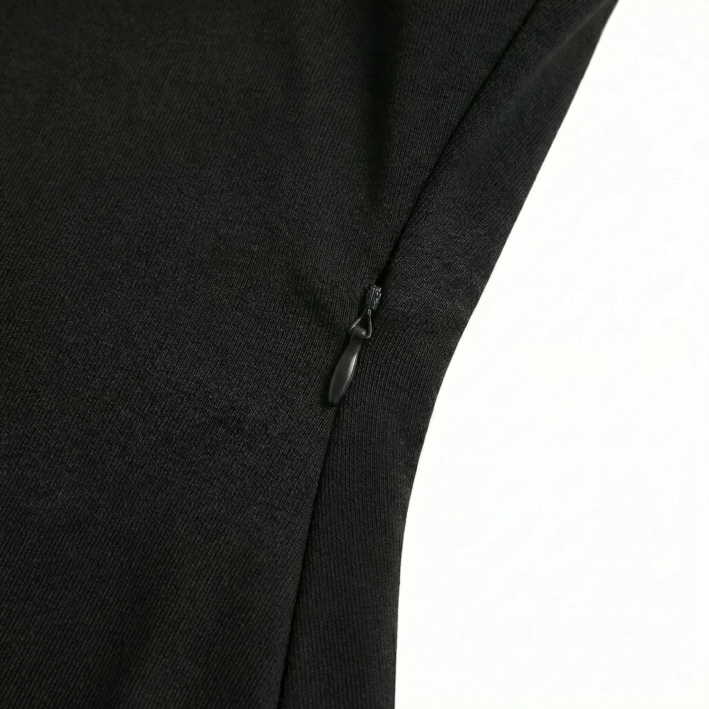Close-up of a black garment with a zipper on a white background