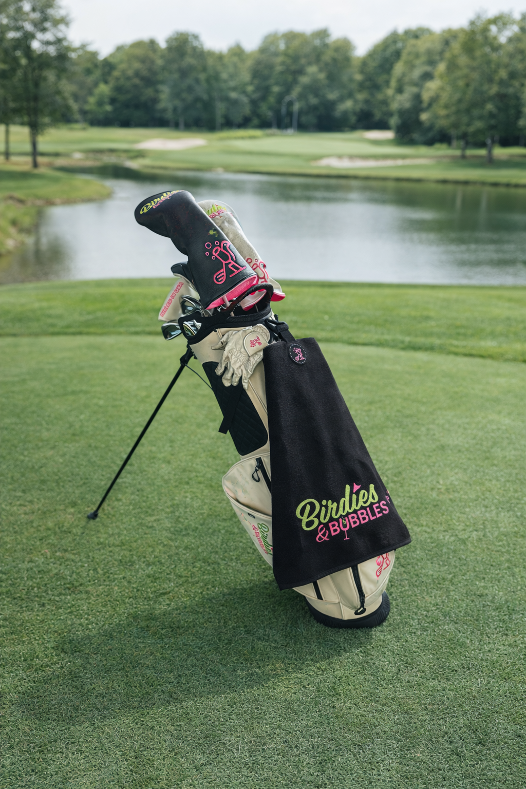 Magnetic golf towel with Birdies & Bubbles logo attached to golf bag