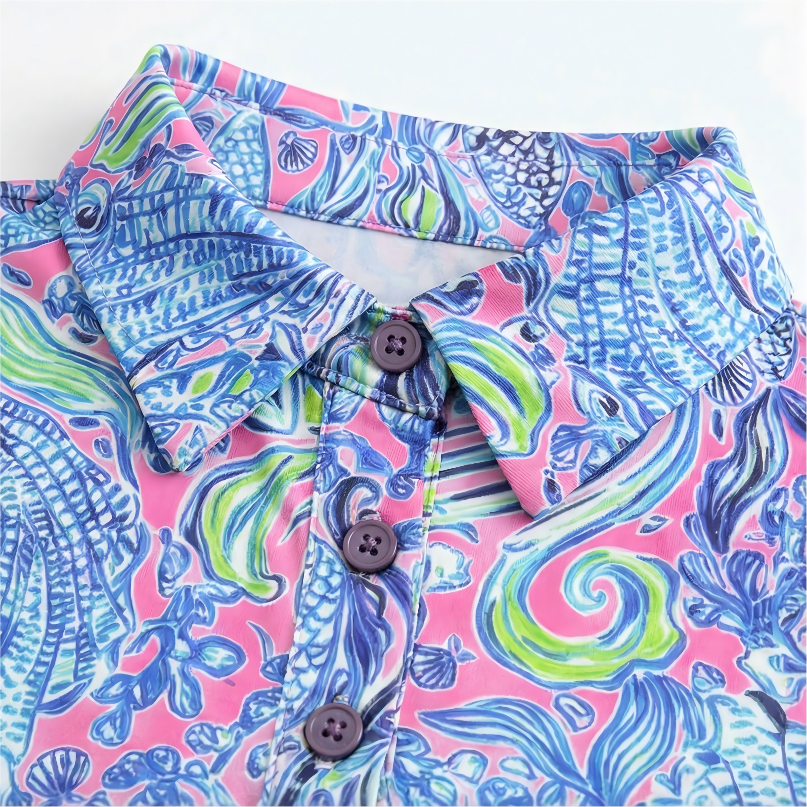 Colorful patterned birdies & bubbles golf dress with buttons on a white background